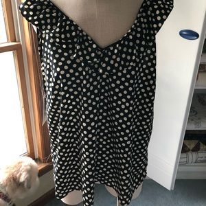 Adorable polka dot top with ruffled neckline.